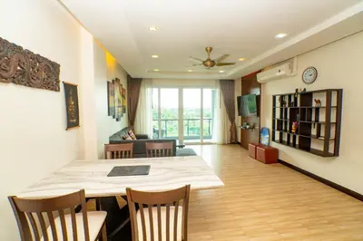 a dining room and living room with a table and chairs at Seaside Haven Karon in Karon Beach