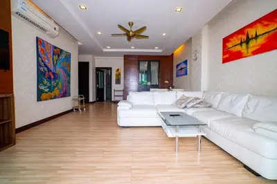 a living room with a white couch and a table at Seaside Haven Karon in Karon Beach