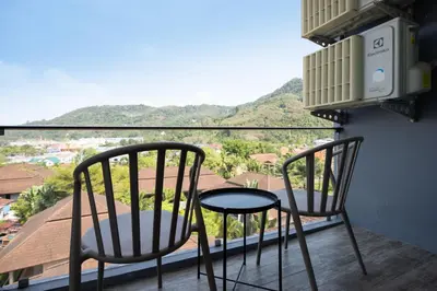 two chairs and a table on a balcony with a view at Tropics Kamala Hill View Apartment CTG D709, near Beach and Fantasea in Kamala Beach