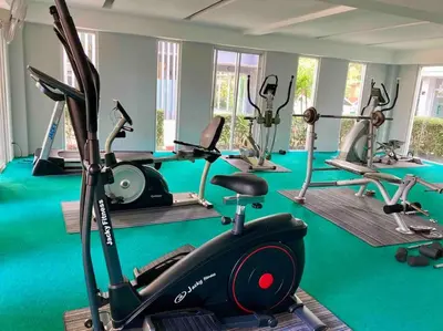 a gym with several treadmills and exercise bikes at Chez Wanida - apartment Krabi in Klong Muang Beach