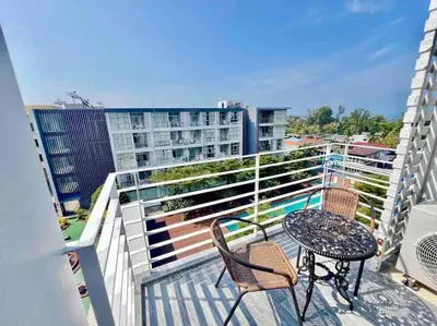 a balcony with a table and chairs on a building at Chez Wanida - apartment Krabi in Klong Muang Beach