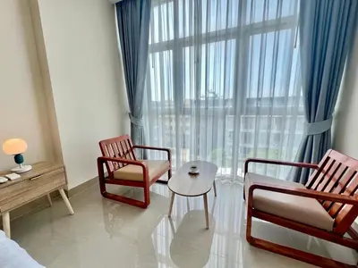 a room with two chairs and a table and a window at Chez Wanida - apartment Krabi in Klong Muang Beach