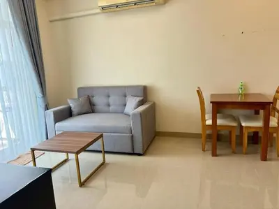 a living room with a couch and a table at Chez Wanida - apartment Krabi in Klong Muang Beach