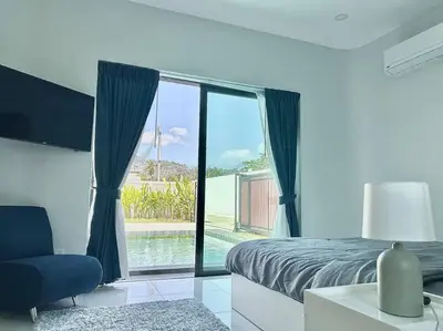 a bedroom with a bed and a view of a pool at Costa Lota villa, brand new, 3 bedroom, in rawai V35 in Rawai Beach