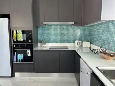 a kitchen with gray cabinets and green tile at Costa Lota villa, brand new, 3 bedroom, in rawai V35 in Rawai Beach