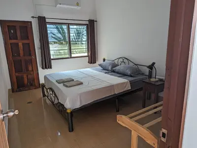 a bedroom with a bed and a window at Rawai-Casevacanze in Rawai Beach