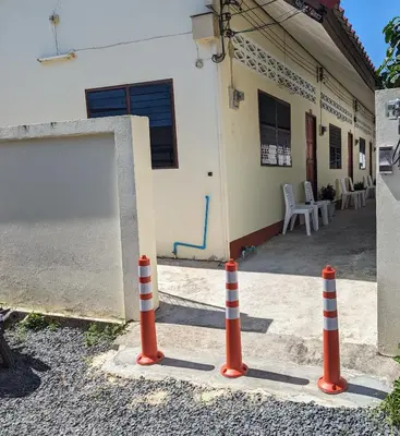 a group of orange traffic cones in front of a house at Rawai-Casevacanze in Rawai Beach