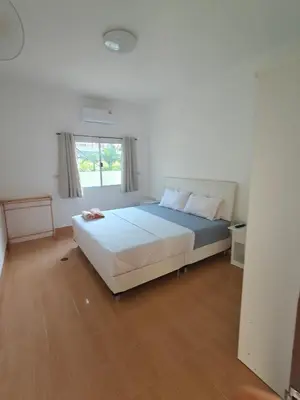 a bedroom with a large bed with a window at Rawai-Casevacanze in Rawai Beach