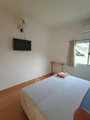 a bedroom with a white bed and a fan at Rawai-Casevacanze in Rawai Beach