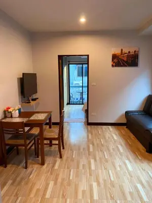 a living room with a table and a couch at Hm House Patong in Patong Beach
