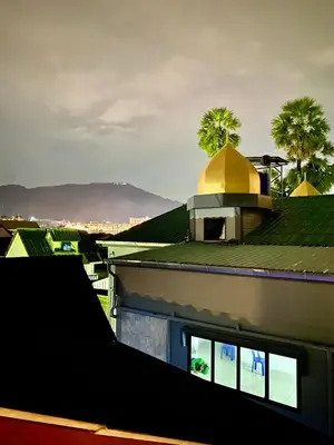 a building with a yellow dome on top of it at Hm House Patong in Patong Beach