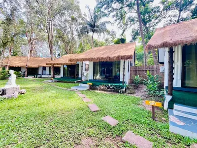 a group of cottages with a grass roof at Long Beach Club Krabi in Ban Nong Thale