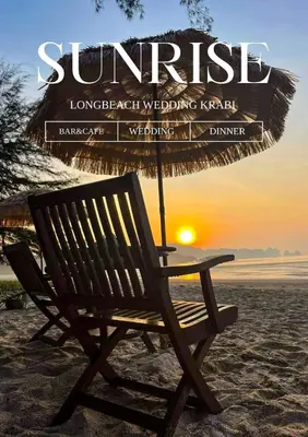 a chair sitting on the beach with an umbrella at Long Beach Club Krabi in Ban Nong Thale
