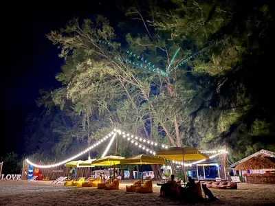 a group of umbrellas on a beach at night at Long Beach Club Krabi in Ban Nong Thale