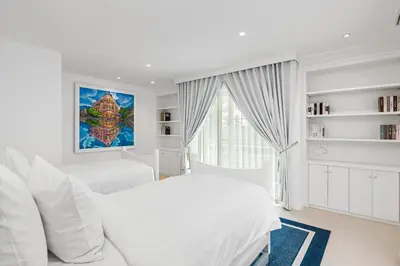 a white bedroom with two beds and a window at Carpe Diem Beach Villa in Natai Beach