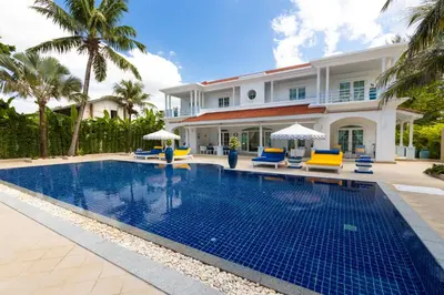 a swimming pool in front of a villa at Carpe Diem Beach Villa in Natai Beach