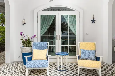 two chairs and a table on a porch at Carpe Diem Beach Villa in Natai Beach