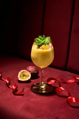 a drink sitting on a table with a red table cloth at Kamala Havana Hotel and Cafe in Kamala Beach