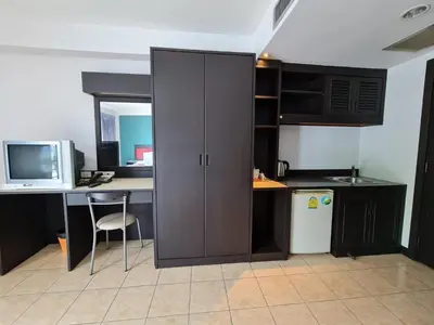 a kitchen with a desk with a computer and a cabinet at Desa Phuket in Phuket Town