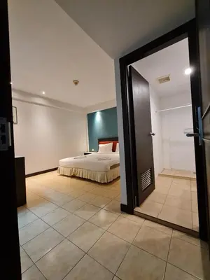 a bedroom with a bed and a sliding glass door at Desa Phuket in Phuket Town