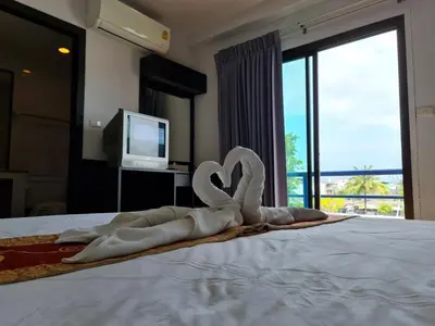 a couple of towel swans sitting on top of a bed at Desa Phuket in Phuket Town