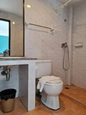a bathroom with a toilet and a sink and a shower at Desa Phuket in Phuket Town