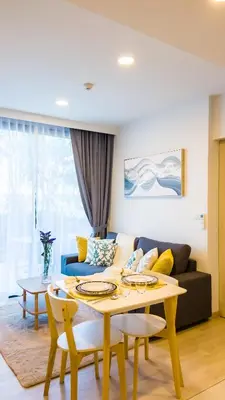 a living room with a table and a couch at Апартаменты в Laguna Skypark с террасой in Bang Tao Beach