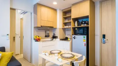 a small kitchen with a table and a refrigerator at Апартаменты в Laguna Skypark с террасой in Bang Tao Beach