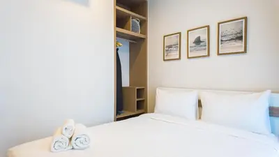 a bedroom with a bed with two slippers on it at Апартаменты в Laguna Skypark с террасой in Bang Tao Beach