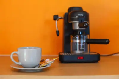 a coffee maker and a cup on a table at Bangtao Guest House in Bang Tao Beach