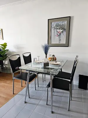 a dining room with a glass table and chairs at Patong Tower Apartment in Patong Beach