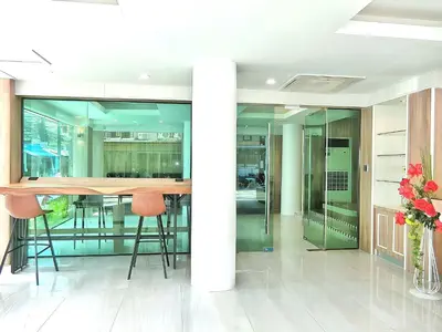 a conference room with a table and two stools at Sira Boutique, Patong in Patong Beach