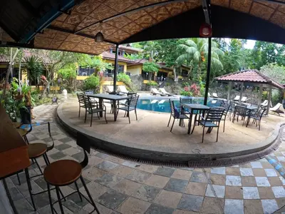 a patio with tables and chairs next to a pool at the hill resort \u5e0c\u5c14\u5ea6\u5047\u5c4b in Patong Beach