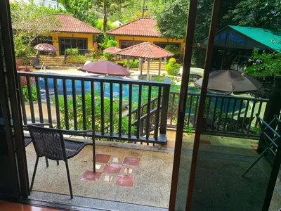 a view of a patio with a chair and umbrellas at the hill resort \u5e0c\u5c14\u5ea6\u5047\u5c4b in Patong Beach