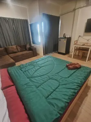a large bed in the middle of a living room at Bonanza Patong Beach1 100m to Beach Sun Room in Patong Beach
