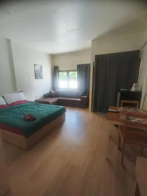 a bedroom with a bed and a couch and a table at Bonanza Patong Beach1 100m to Beach Sun Room in Patong Beach