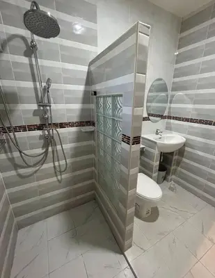 a bathroom with a shower and a toilet and a sink at Villa Patong in Ban Na Nai