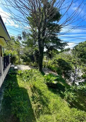 a yard with a tree and a house at Villa Patong in Ban Na Nai