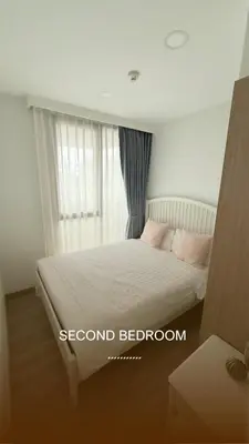 a bedroom with a bed with pink pillows at Skypark Laguna Phuket in Bang Tao Beach