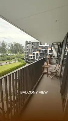 a balcony with two chairs and a view of a city at Skypark Laguna Phuket in Bang Tao Beach