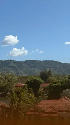a view of a town with trees and mountains at Skypark Laguna Phuket in Bang Tao Beach