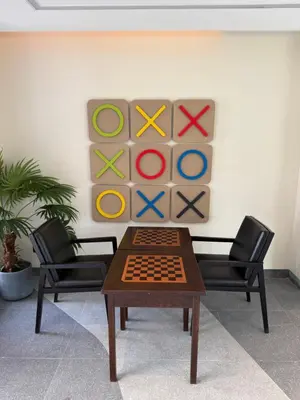 a room with a table and two chairs and a painting at Skypark Laguna Phuket in Bang Tao Beach