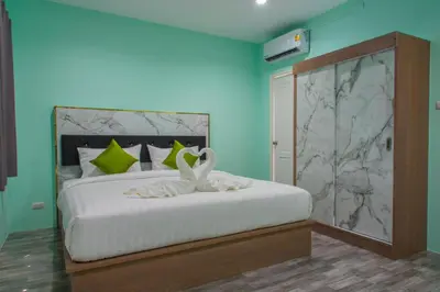 a bedroom with a bed with two swans on it at Anatasia Apartment Phuket in Phuket Town