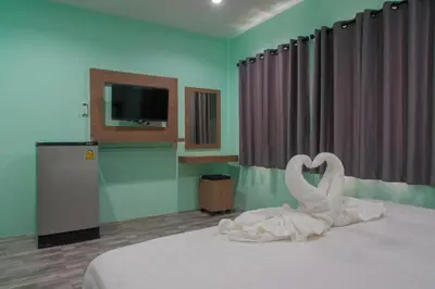 a bedroom with a swan decoration on a bed at Anatasia Apartment Phuket in Phuket Town