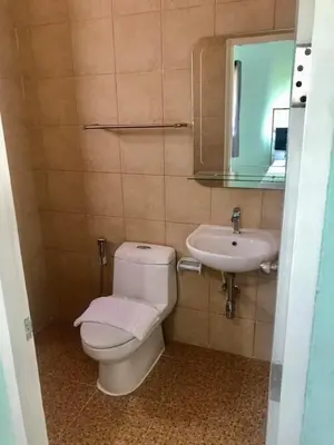 a bathroom with a toilet and a sink at Anatasia Apartment Phuket in Phuket Town