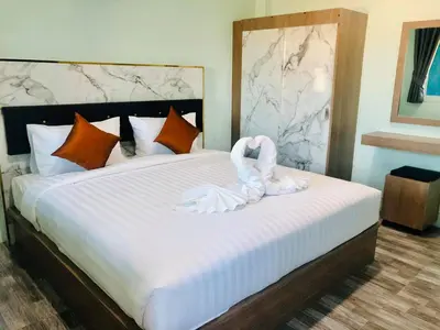 a bedroom with a bed with a swan decoration on it at Anatasia Apartment Phuket in Phuket Town