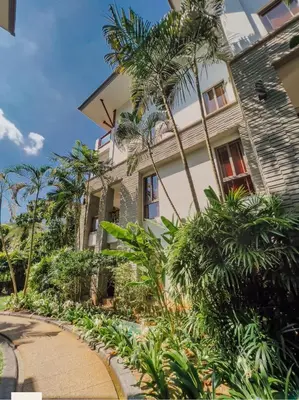 a house with palm trees in front of it at Pearl of naithon two 2 bedrooms in Nai Thon Beach