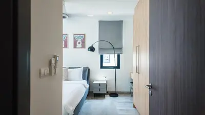 a bedroom with a bed and a lamp in it at Laguna Park Villa in Phuket Town