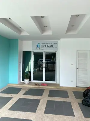 a lobby of a building with a large glass door at Studio Apartment in Phuket Town