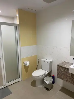 a bathroom with a toilet and a shower at Studio Apartment in Phuket Town